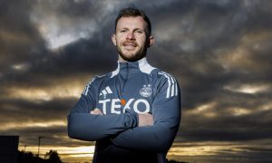 Aberdeen right-back Nicky Devllin at the club's Cormack Park training facility at dusk with clouds gathering behind him.