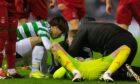 Aberdeen's Ross Doohan lies on the pitch following a collision with Celtic's Kyogo Furuhashi (L). Image; SNS