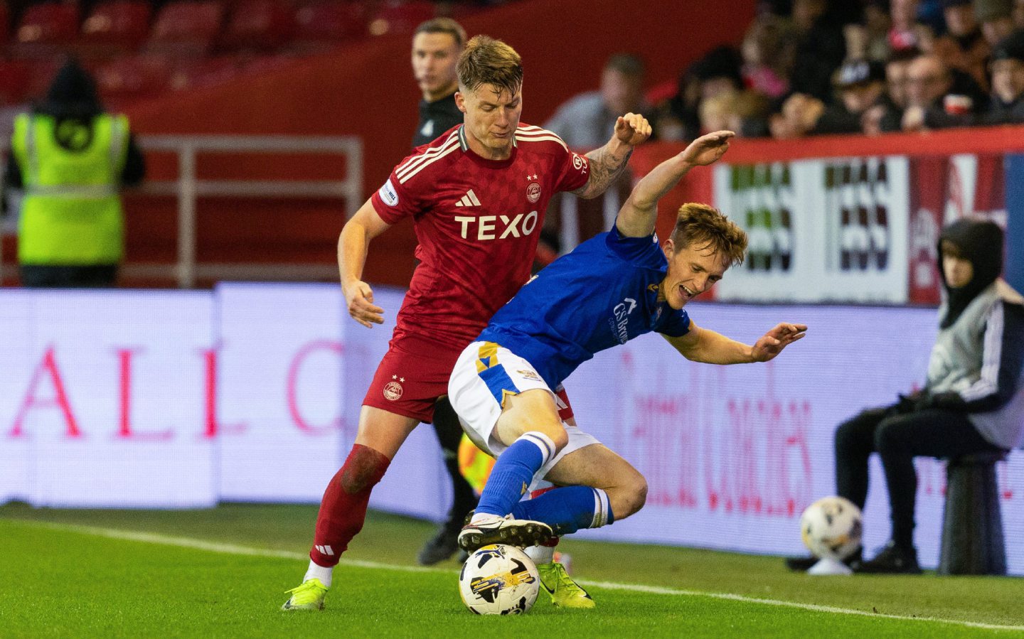 Aberdeen's James McGarry and St Johnstone's Matt Smith in action at Pittodrie Image: SNS