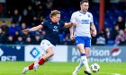 Ross County forward Alex Samuel puts pressure on Rangers defender John Souttar.