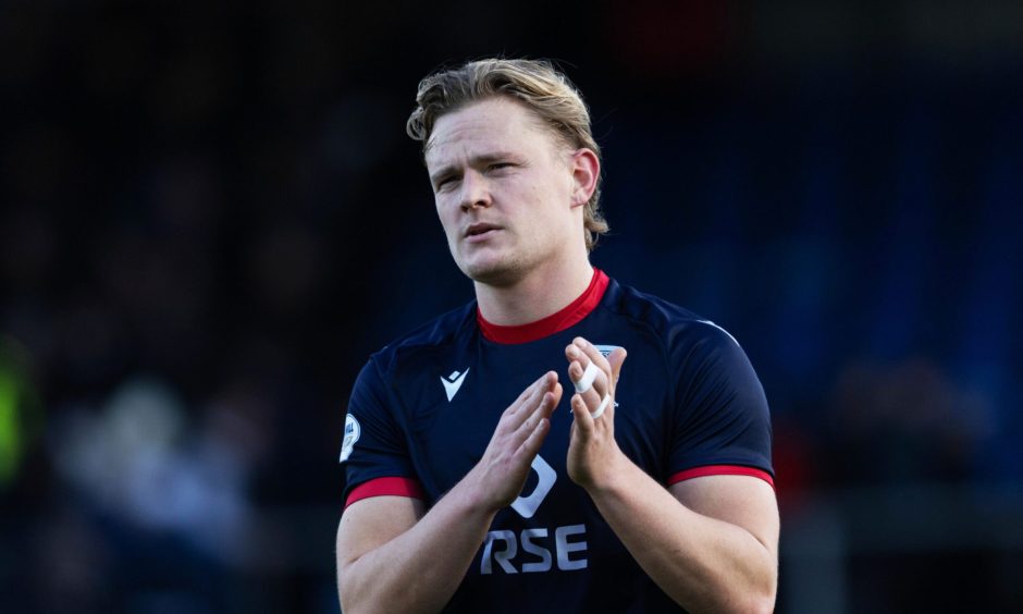 Alex Samuel applauds the Ross County supporters.