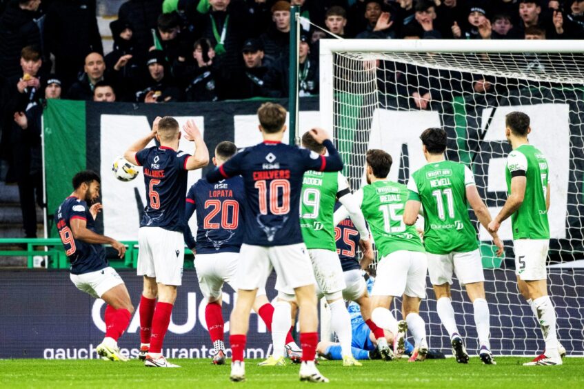 Ross County's Eli Campbell scores to make it 1-0 against Hibernian at Easter Road Stadium. He is pictured, far right, guiding a header into the net inside a packed penalty box, 