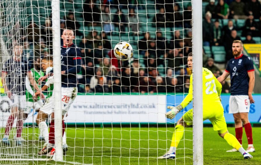 Hibs forward Dwight Gayle scores with a glancing header to make it 1-1 against Ross County - a goal which arrived after five minutes of first half stoppage-time, which was hotly contested by the Dingwall side.