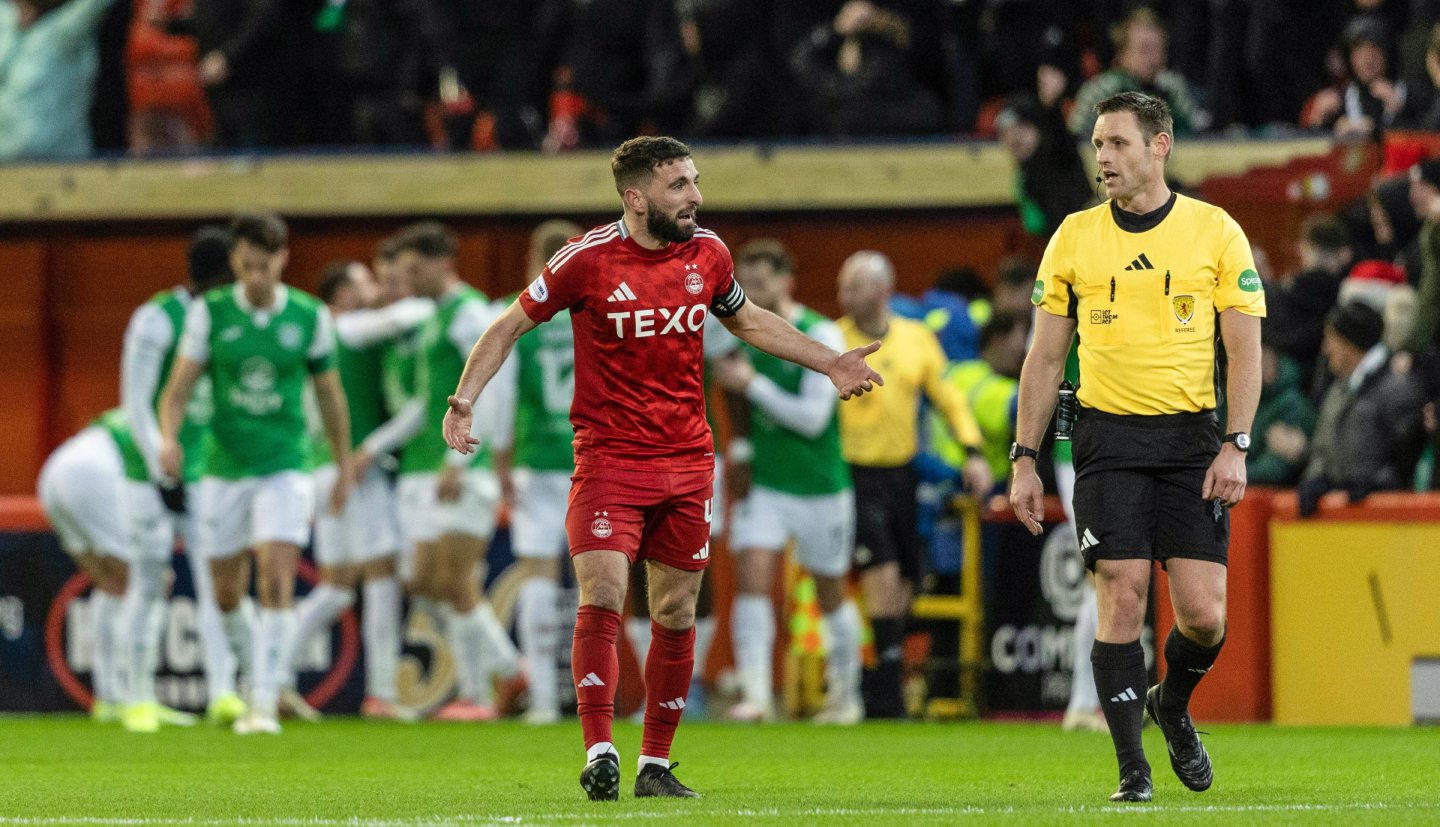 Aberdeen's Graeme Shinnie (L) complains to referee Steven McLean during a Premiership match against Hibs at Pittodrie. Image: SNS 