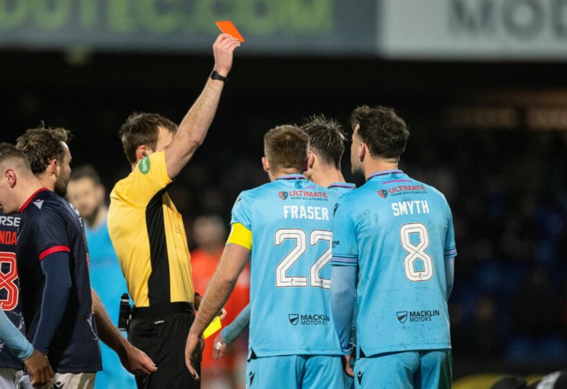 St Mirren's Scott Tanser is shown a red card by referee Iain Snedden for a second booking against Ross County. 