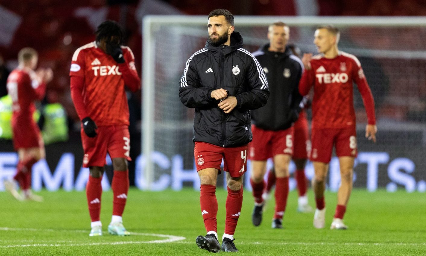 Aberdeen's Graeme Shinnie and his team-mates look dejected at full-time in the 3-1 loss to Hibs. Image: SNS