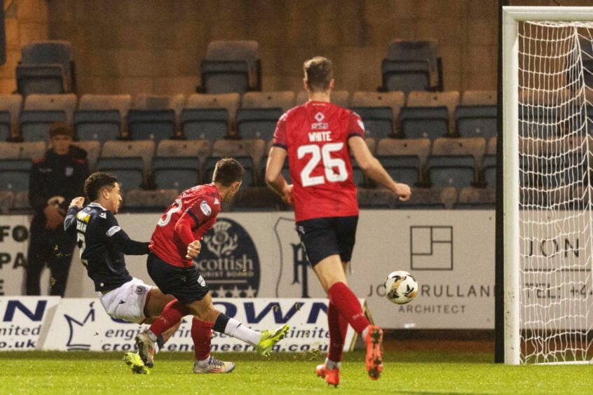 Ross County's Josh Nisbet scores with a low shot to make it 2-0 in his side's 3-0 Premiership win at Dens Park, Dundee, on December 26, 2024.