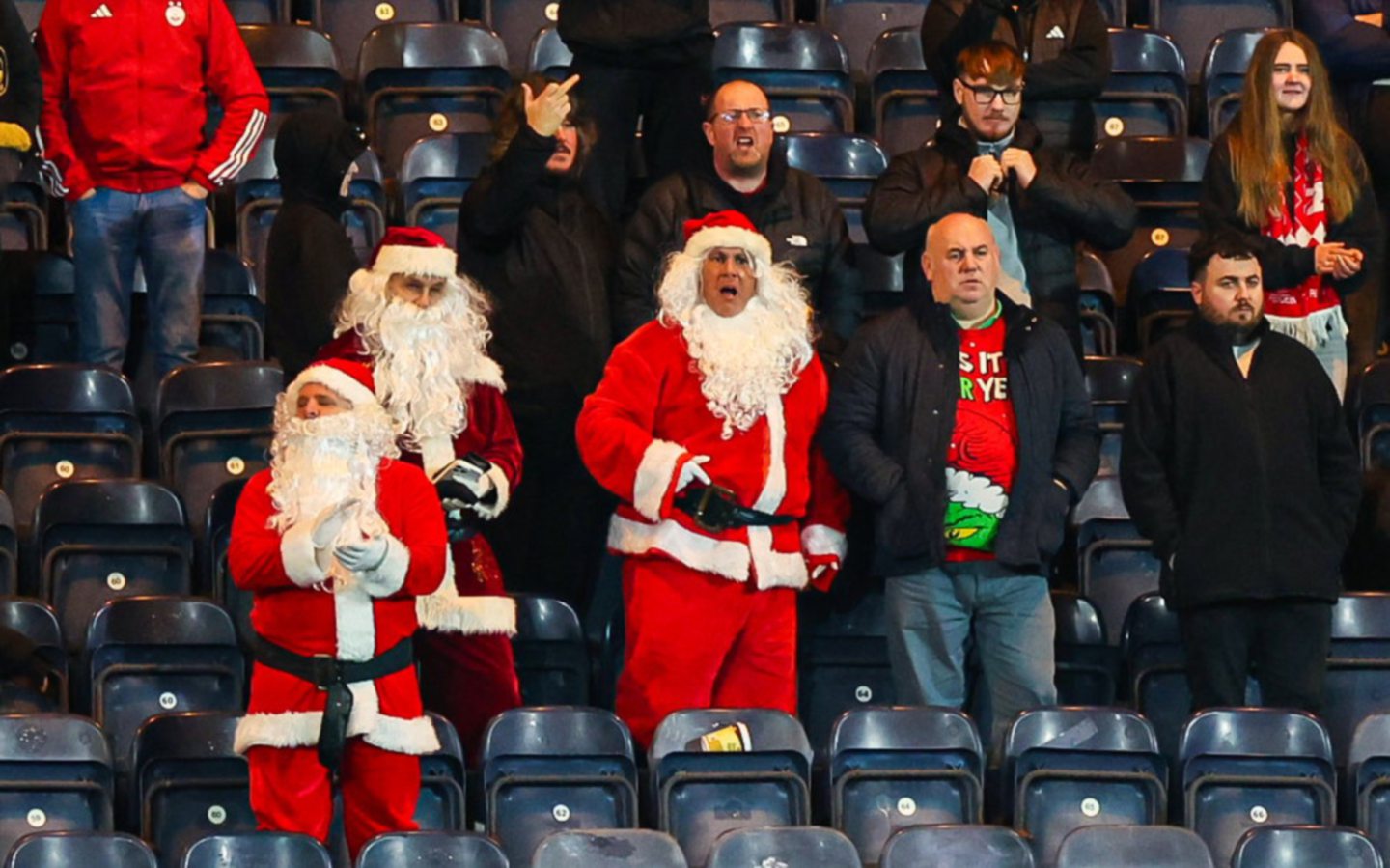 Aberdeen fans dressed as Santa look dejected at full time after the 4-0 loss to Kilmarnock at Rugby Park.