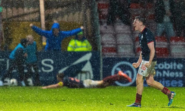 Ross County's George Harmon celebrates after Jordan White (in the background) scores to make it 2-2 against Hearts in the SPFL Premiership match at the Global Energy Stadium, Dingwall, on December 29, 2024.