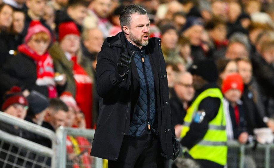 Aberdeen manager Jimmy Thelin stands on the touchline in front of travelling Don fans during the 1-0 Premiership loss to Dundee United at Tannadice.