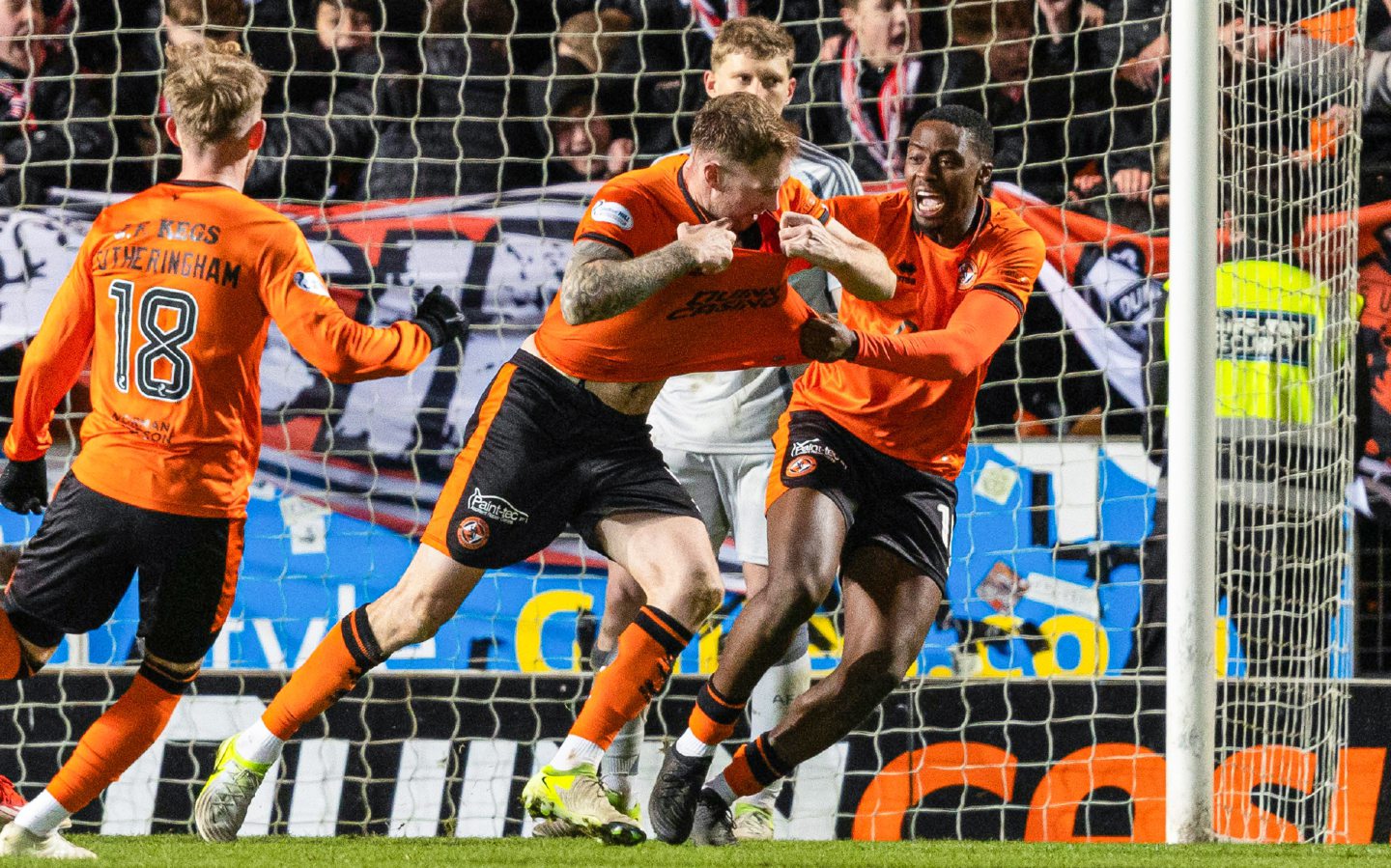 Dundee United's Kevin Holt (C) removes his shirt to celebrate scoring to make it 1-0 against Aberdeen at Tannadice.