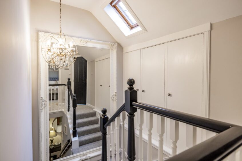 Upstairs landing with a very large mirror at this Mannofield property