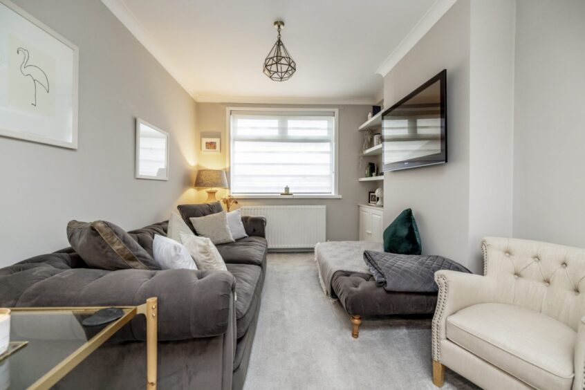 second part of the long lounge with another sofa and footstool, making it ideal for watching TV at this Mannofield property