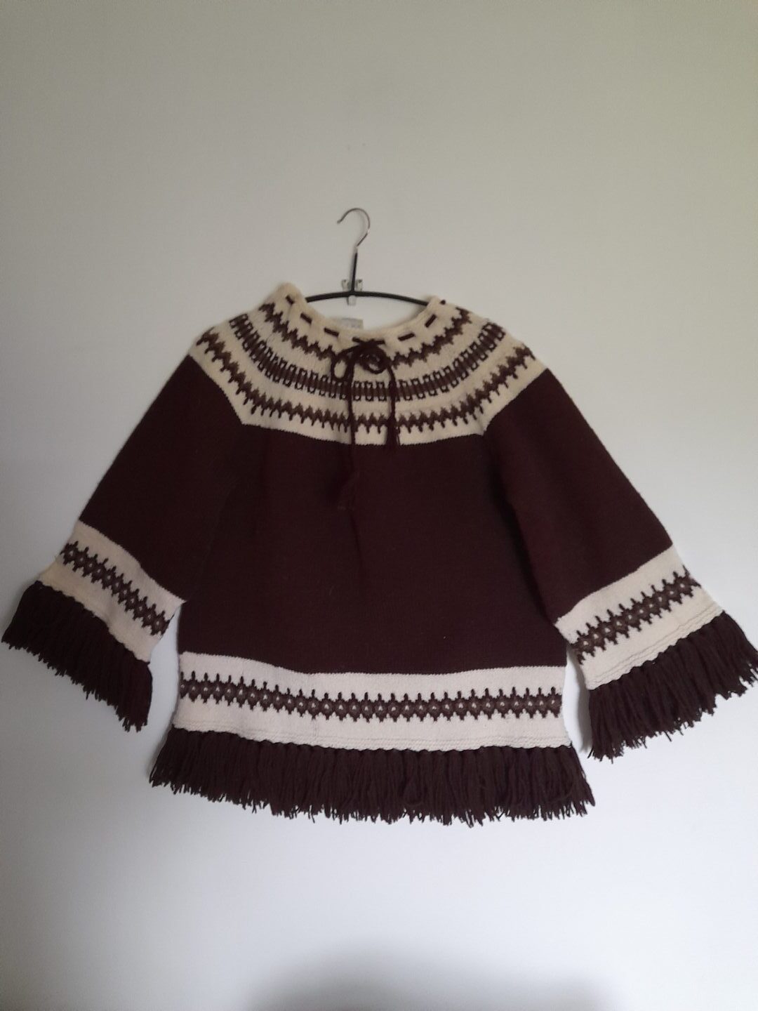 A fringed Norwegian style tunic in burgundy and white.