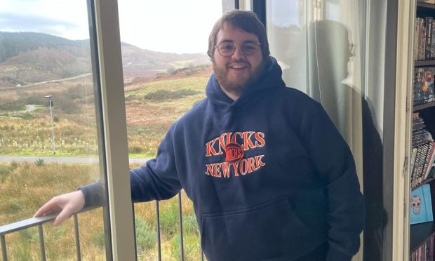 James Strachan standing by a window in his Dunbeg home.