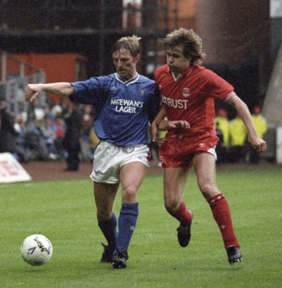 Theo ten Caat challenge Rangers defender Gary Stevens for the ball in a game at Ibrox in September 1991.