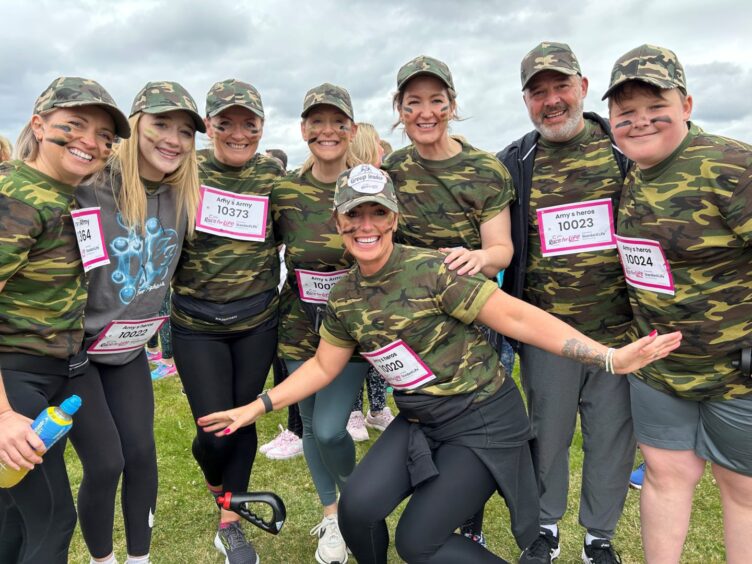 runners in camouflage tops and caps pose for a pic at the Race for Life in Aberdeen last year.