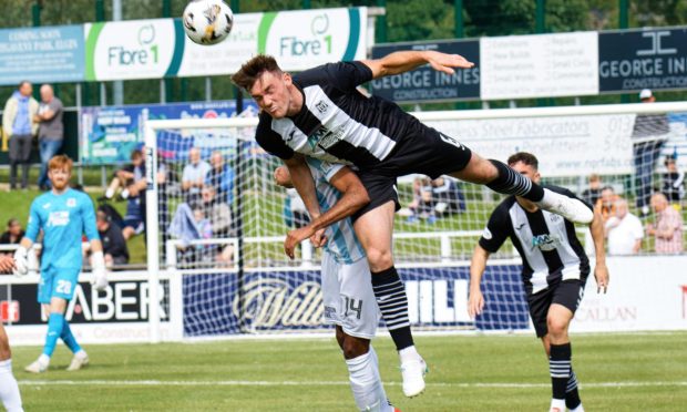 Elgin City defender Jack Murray is pictured heading the ball clear during his team's 4-2 win over East Fife on August 3, 2024.