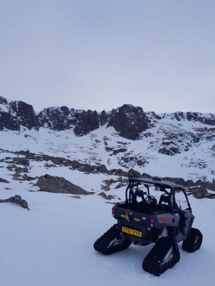 Snow mobile on Mountainside covered by snow