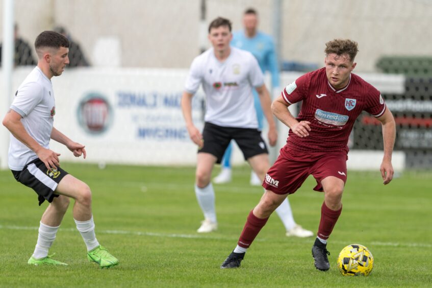 Keith's Michael Ironside, right, dribbling with the ball