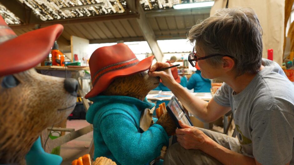 Artist painting Paddington Bear statue