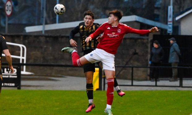 Deveronvale's Jack Mitchell, right, battles with Kai Watson of Huntly. Pictures by Kenny Elrick/DCT Media.