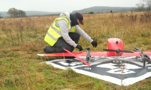 Man in high vis working on drone