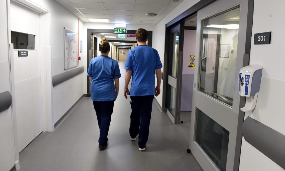 Nurses walking down ward