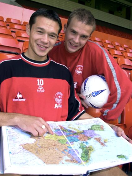 Derek Young, left, and Darren Mackie use an atlas to plot a route to Moldova after being drawn against Nistru Otaci in the Uefa Cup in 2002.