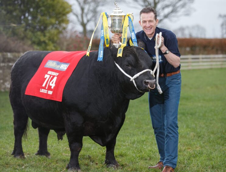 Aberdeen FC legend Brian Irvine with a bull and the trophy as he takes part in a Scottish Cup press call.