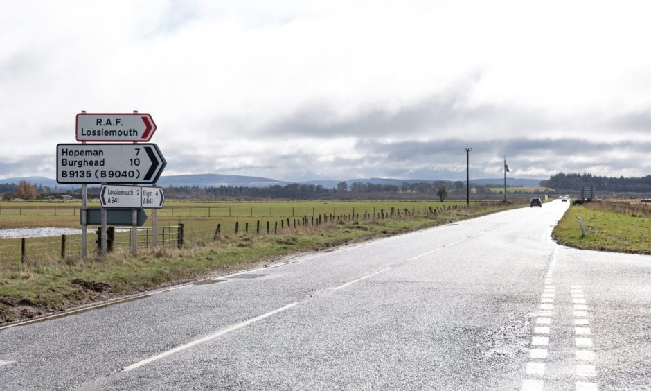 Looking down long straight on A941 Elgin to Lossiemouth road at Muirton junction. 