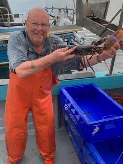 Frank shows off a lobster