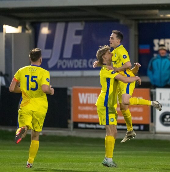 Kevin Fraser is lifted up by Buckie team-mate Lyall Keir after scoring