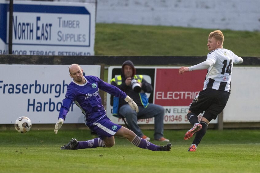 Fraserburgh's Logan Watt, right, shoots past the Buckie goalkeeper Mark Ridgers.