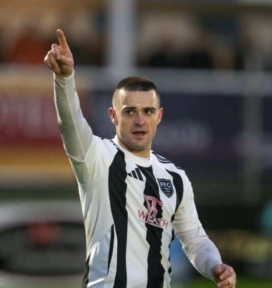 Scott Barbour raises his right arm in celebration after scoring for Fraserburgh.