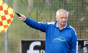 Skye stalwart Donnie Martin taking the role of goal judge in a match with Glenurquhart.