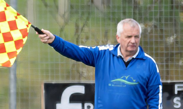 Skye stalwart Donnie Martin taking the role of goal judge in a match with Glenurquhart.