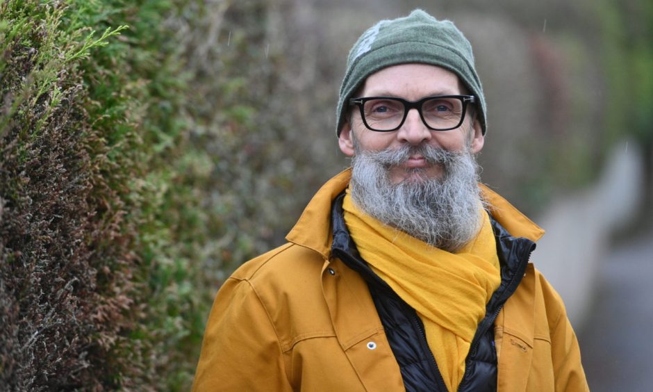 Draek Van Der Horn in yellow jacket and green beanie hat. 