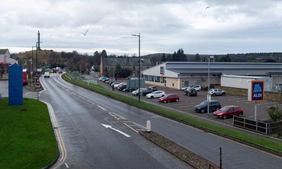 Looking down A96 in Elgin with Aldi on right and bus station on left. 