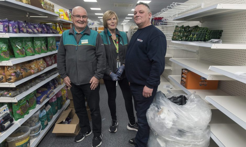 Poundland staff stacking shelves. 