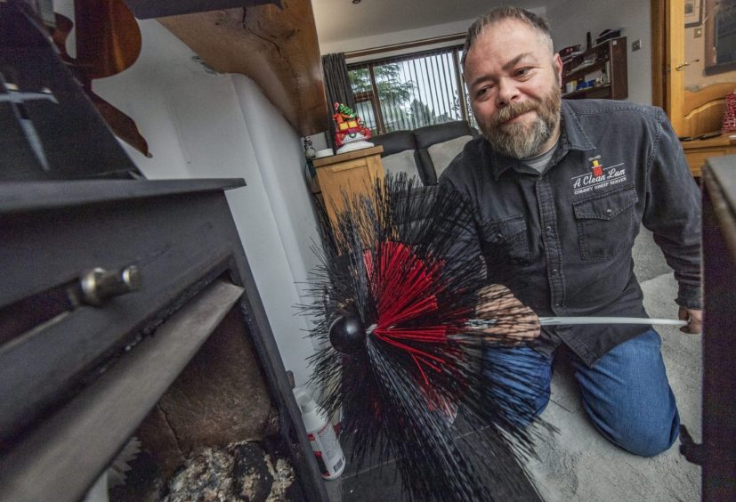 Stafford Turnidge sweeping a chimney. 