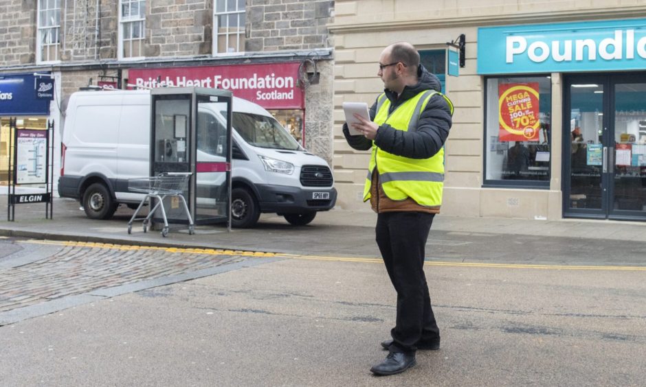 Reporter David Mackay with notepad outside Poundland. 