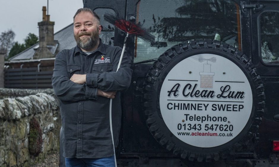 Staffy standing in front of jeep with A Clean Lum logo. 