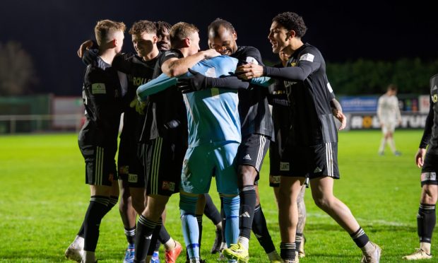 Formartine United goalkeeper Ewen Macdonald (in blue) is mobbed by his team-mates after saving Callum Duncan's penalty in their shoot-out success against Inverurie Locos in the Aberdeenshire Shield. Pictures by Kenny Elrick/DCT Media.