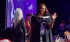 A graduate waves to family and friends as she leaves the stage. All images: Kenny Elrick/DC Thomson