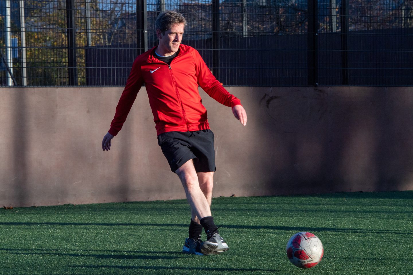 Andy Morton kicking a ball at 5ives Football on Nelson Street, Aberdeen. 