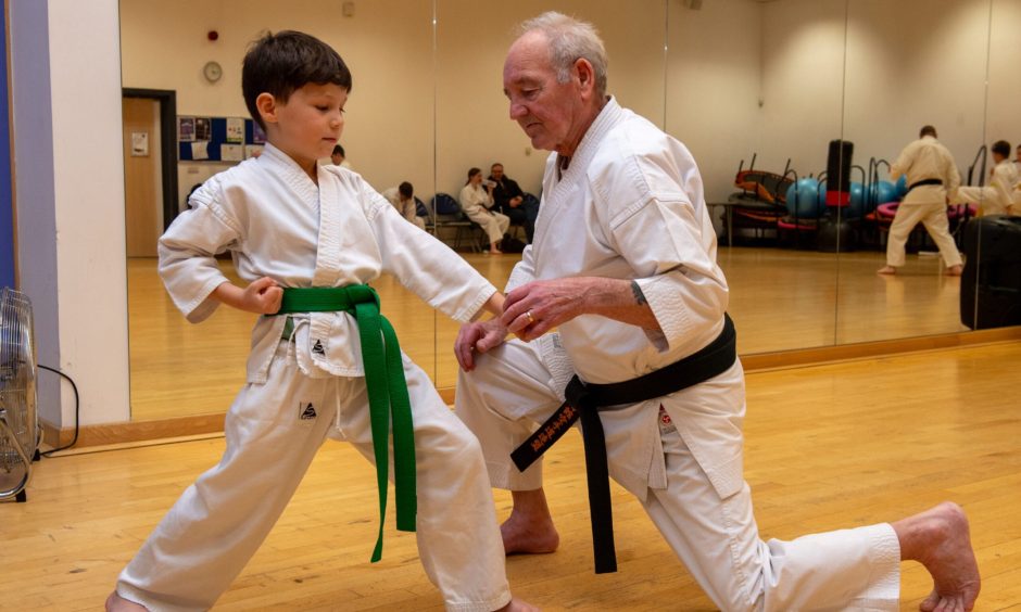 Sandy teaching one of his students Howie Stephen, 6. Image: Kenny Elrick/DC Thomson