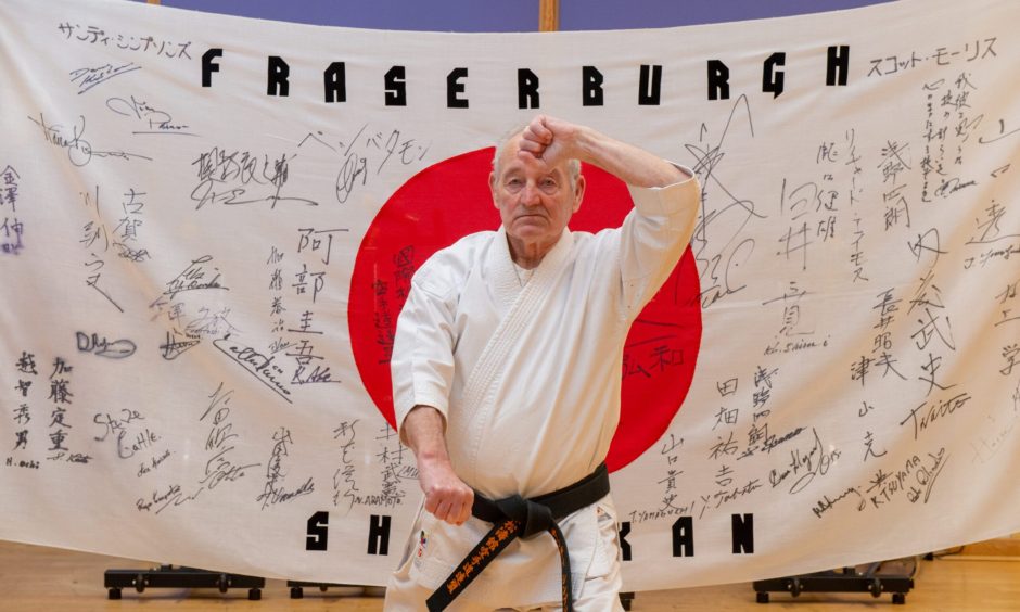 Sandy Infront of his one-of-a-kind Fraserburgh Shotokan flag. Image: Kenny Elrick/DC Thomson