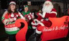 Wilma McPake alongside 'head-elf' Paul Crookbain and Santa. Image: Kenny Elrick/ DC Thomson.