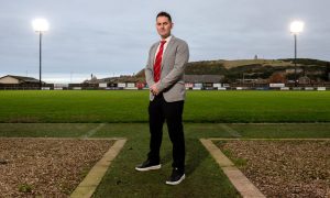 Deveronvale chairman Aaron Lorimer at Princess Royal Park, flanked by two of the new floodlights. Pictures by Kenny Elrick/DCT Media.